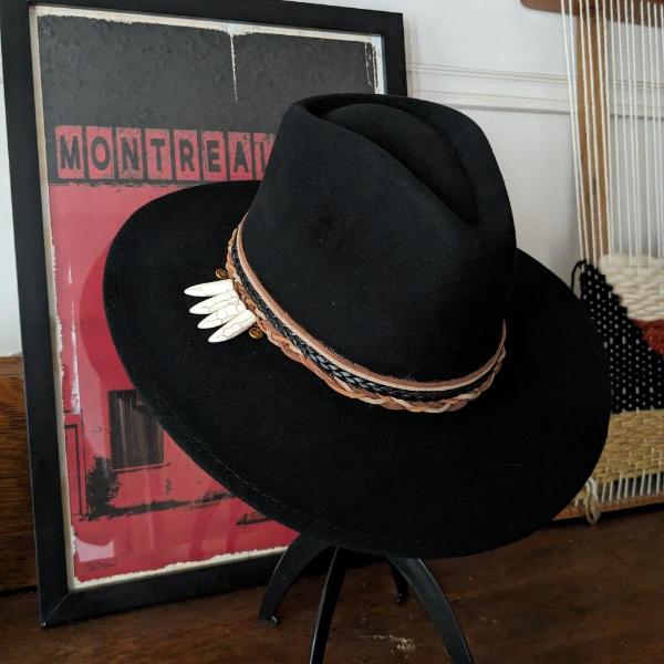 Black Felt hat , 4 laces at the base of the crown stack on top of one another in leather and different colors